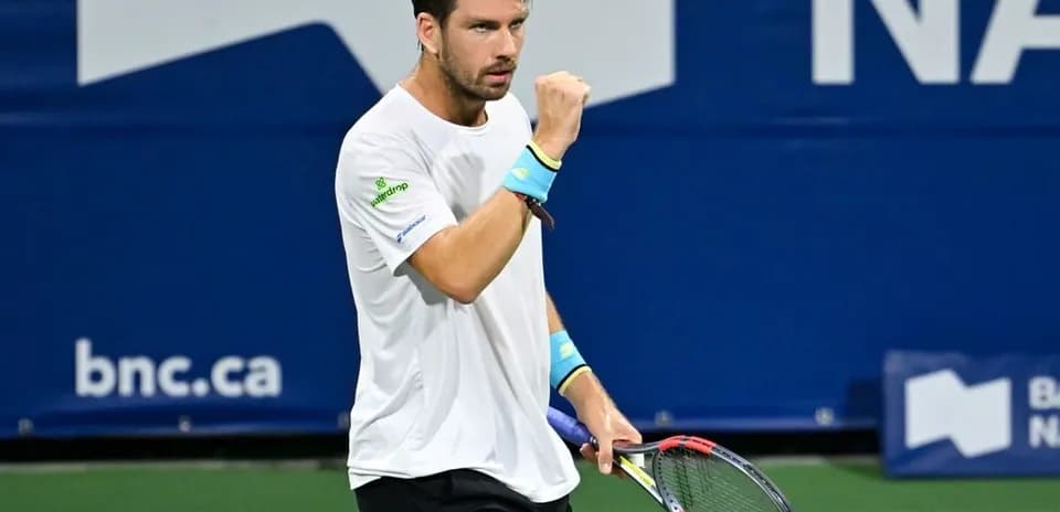 Tennis player celebrating with raised fist on court