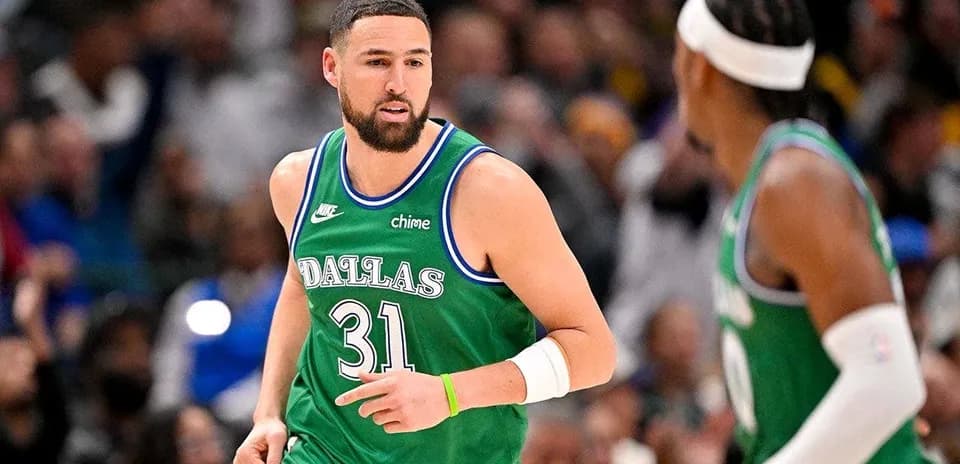 Basketball player in green Dallas jersey during game