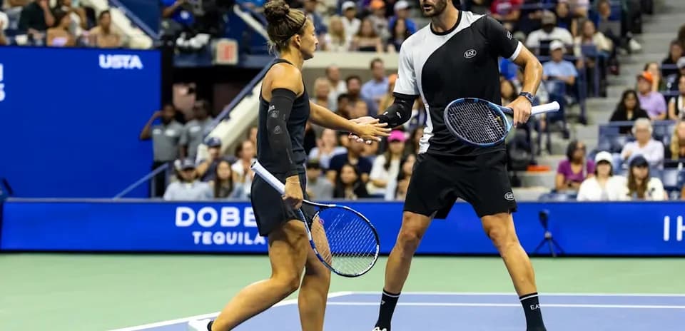 Tennis players exchanging a handshake on court