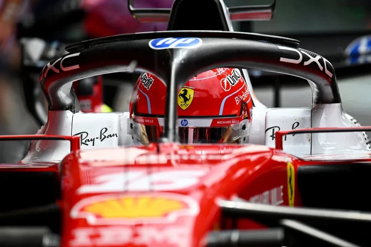 F1 driver in Ferrari car during race preparation