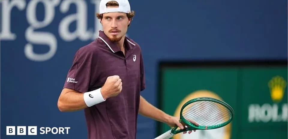 Tennis player celebrating with racket during match