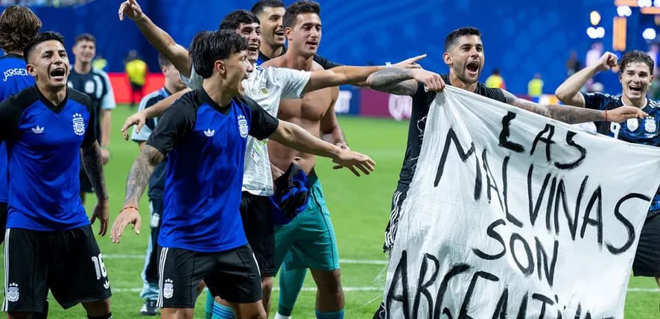 Argentinian players celebrating with banner after match