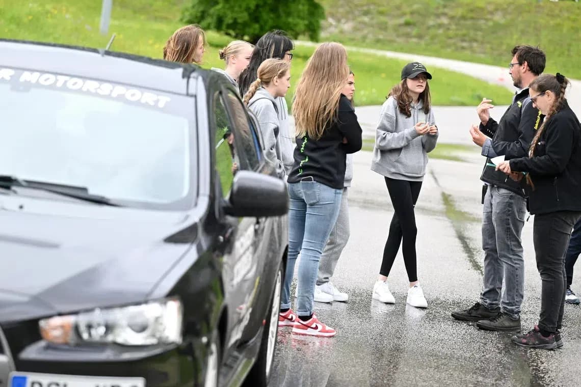 Group discussing on the roadside near a car