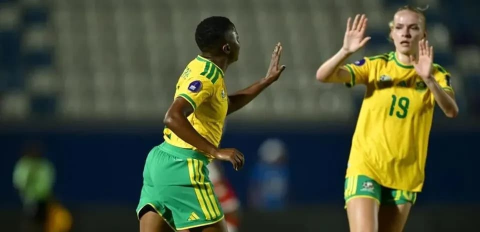 Two players in yellow jerseys during match action