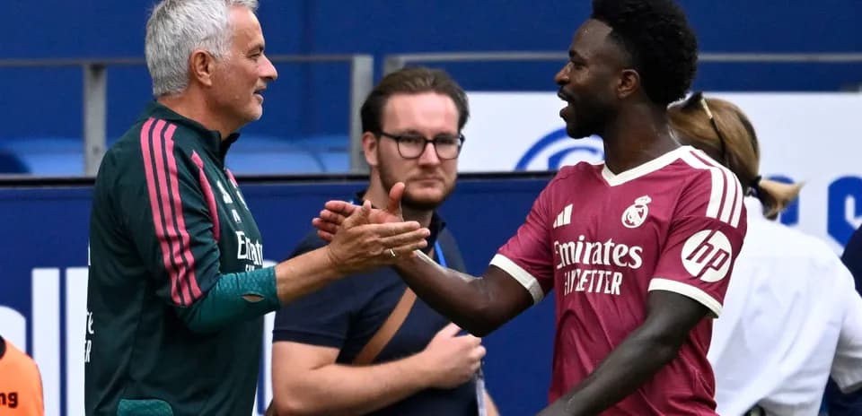 Mourinho and player shaking hands during match