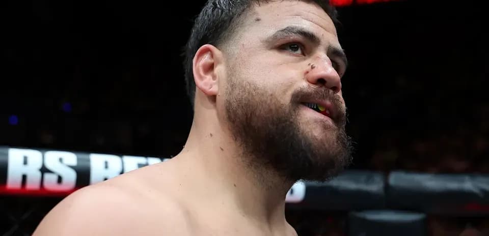 Fighter in the octagon with mouthguard visible