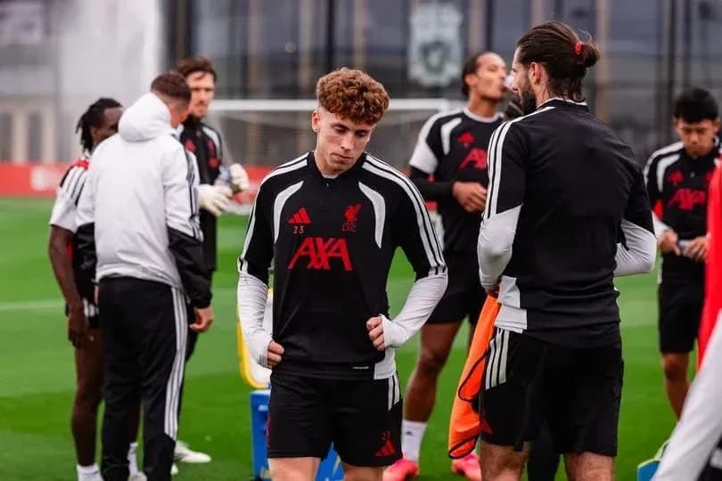 Liverpool players during training session on pitch