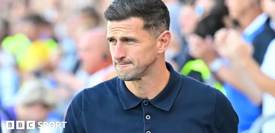 Men's football manager walking on the sidelines