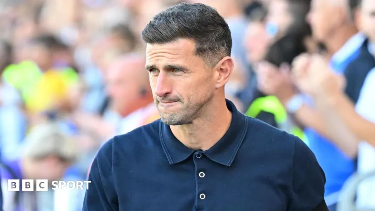 Men's football manager walking on the sidelines