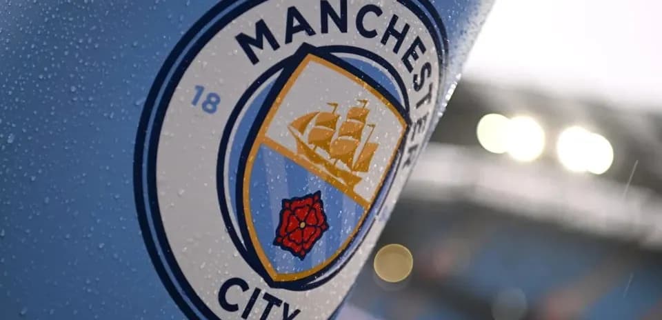 Manchester City club logo with raindrops on surface