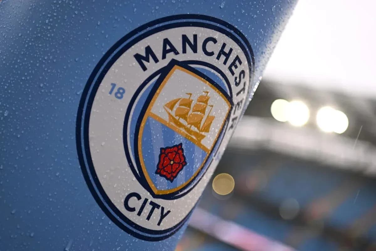 Manchester City club logo with raindrops on surface