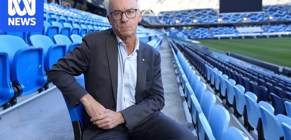 Man seated in empty stadium stands