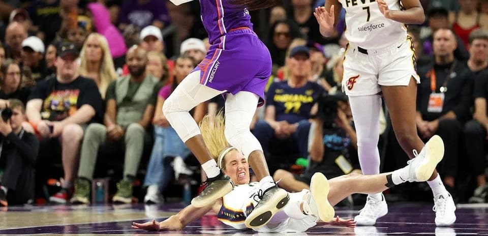 Basketball players competing for the ball on court