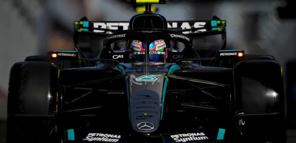Formula 1 car racing on track with driver visible