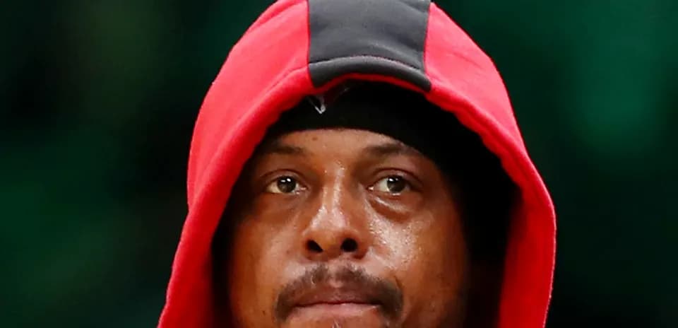 Basketball player wearing a red hoodie on court