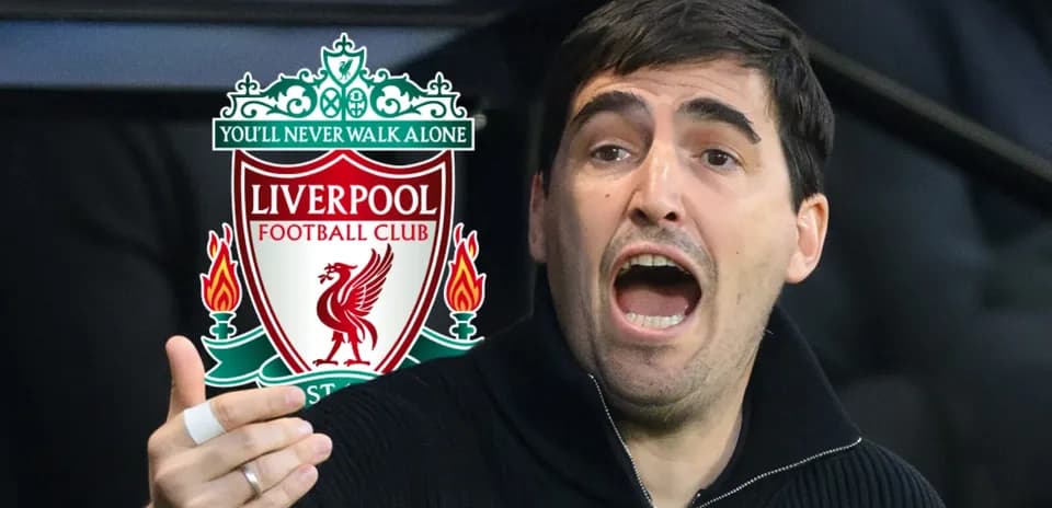 Man gesturing passionately near Liverpool FC logo
