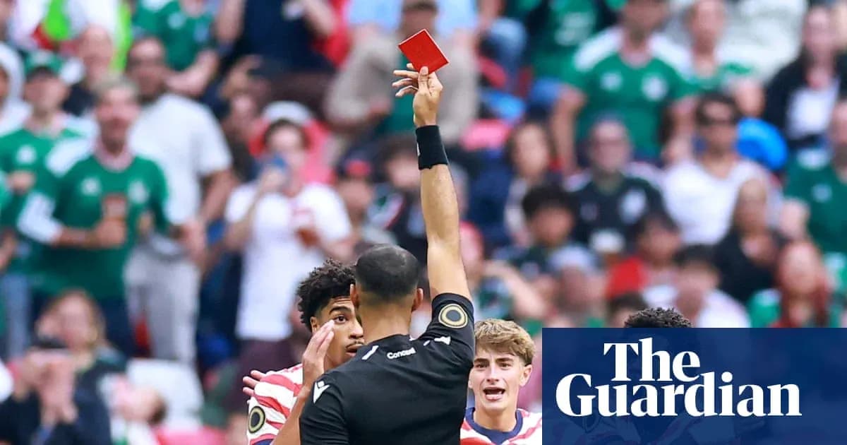 Referee showing red card to player during match