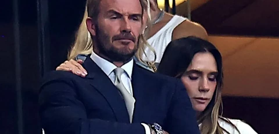David Beckham and woman in a stadium box