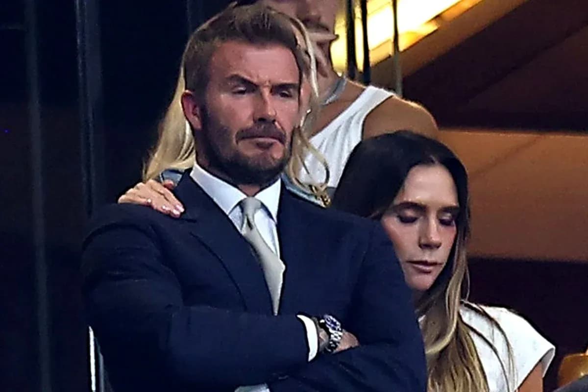 David Beckham and woman in a stadium box