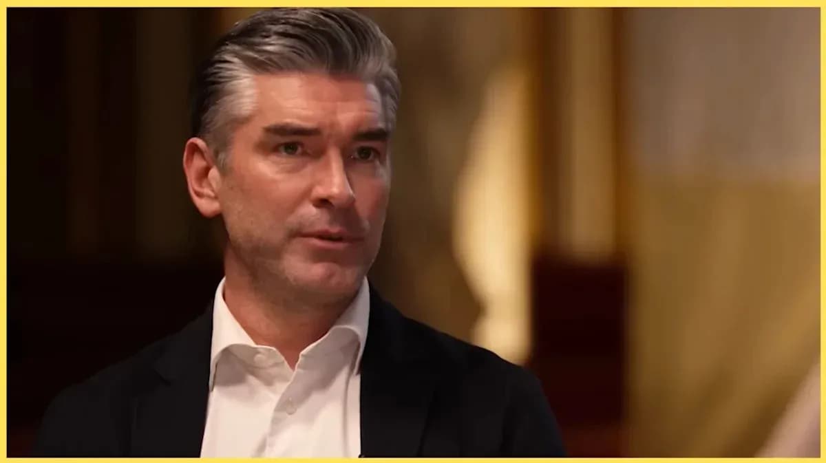 Man speaking during an interview in formal setting