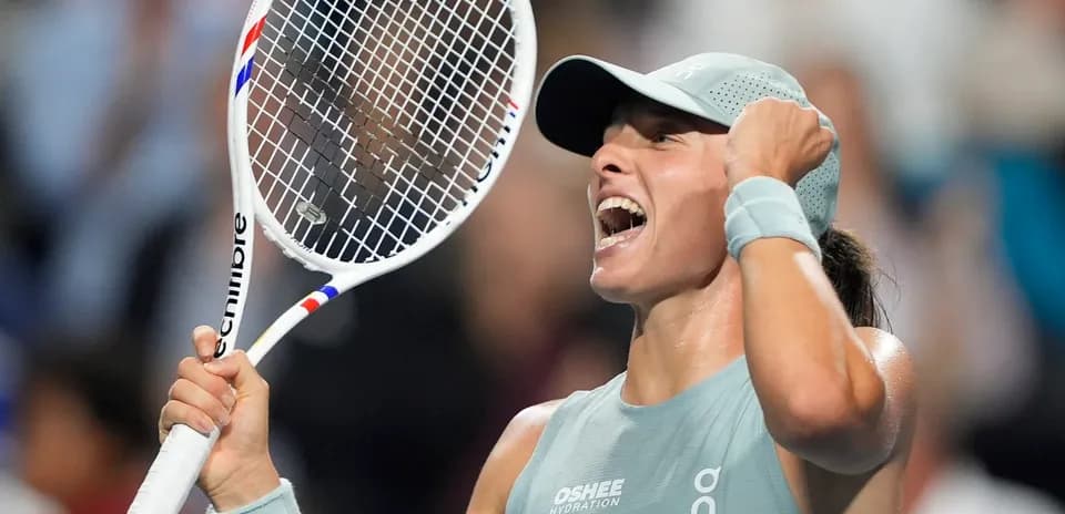 Tennis player celebrating victory with racket raised