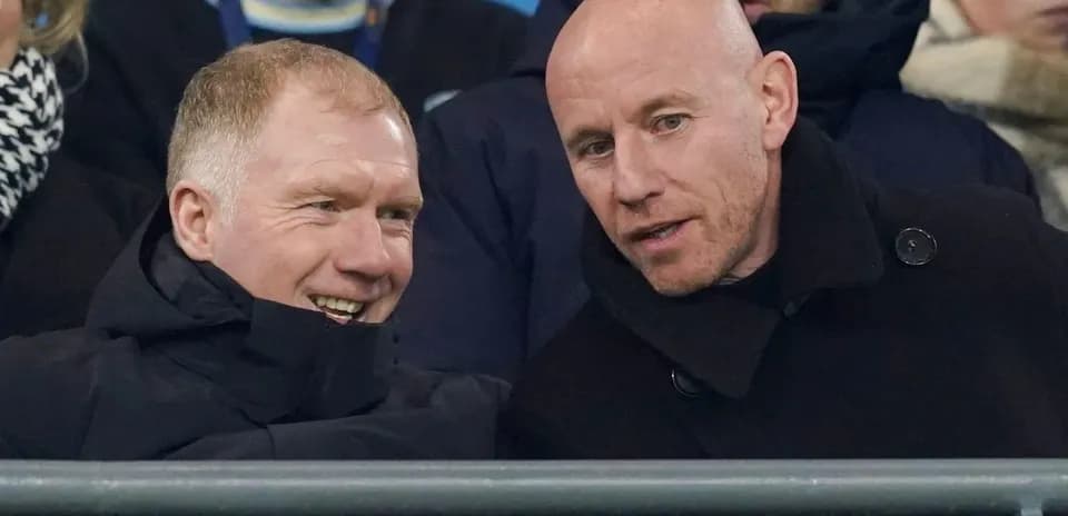Two men chatting in the stadium stands