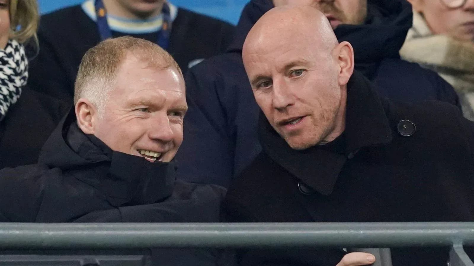 Two men chatting in the stadium stands