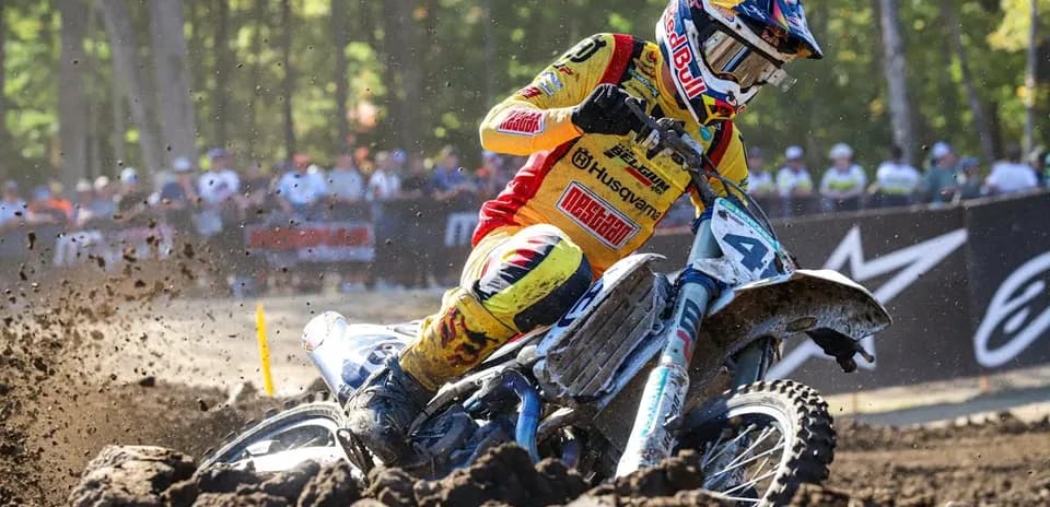 Motocross racer navigating through muddy terrain