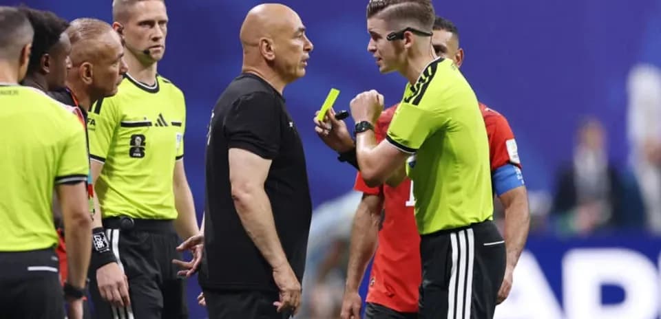 Referees discussing with team officials during match