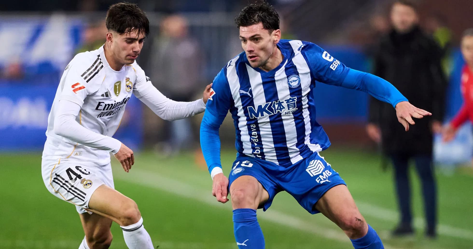 Two players competing for the ball on the field