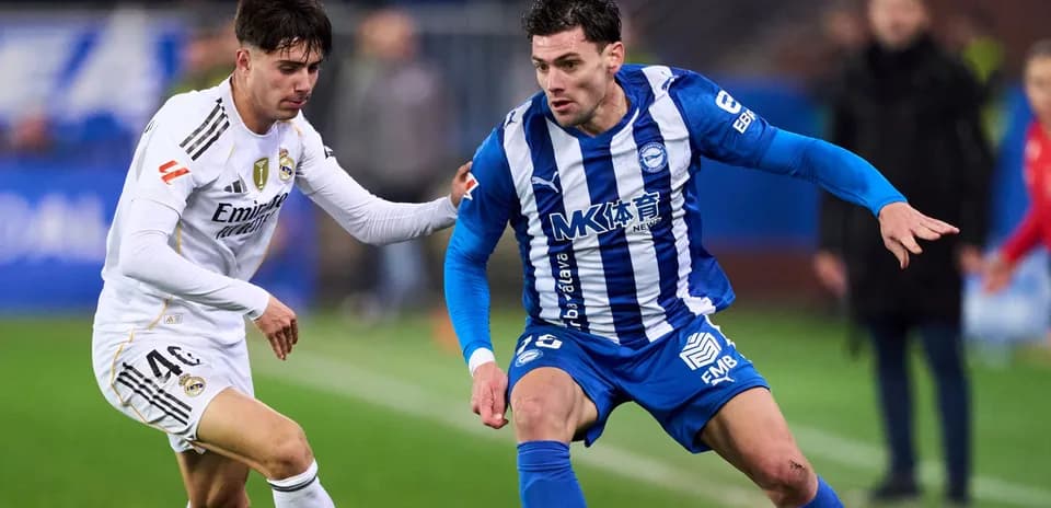 Two players competing for the ball on the field