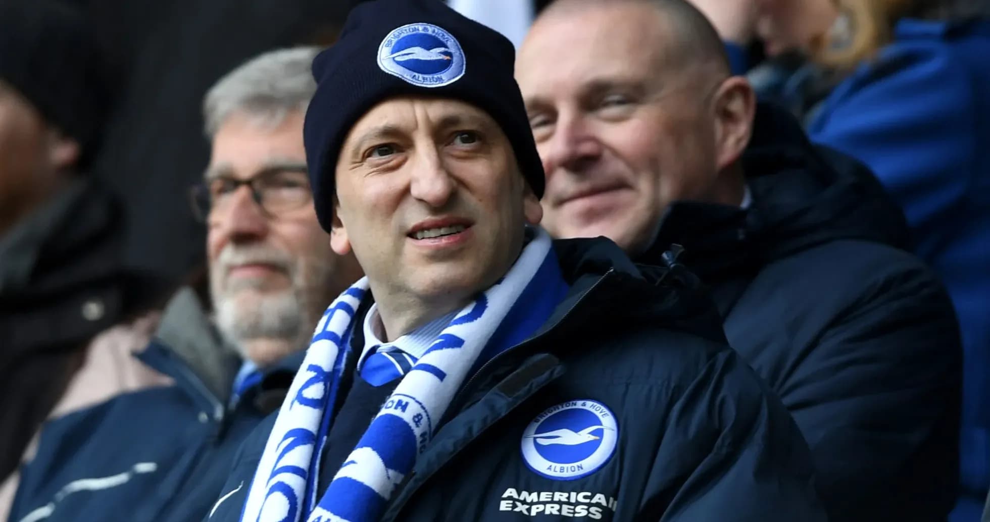 Fan wearing Brighton scarf at football match