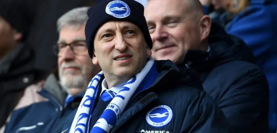 Fan wearing Brighton scarf at football match