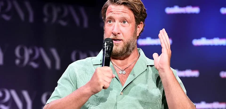 Speaker gesturing while holding a microphone on stage