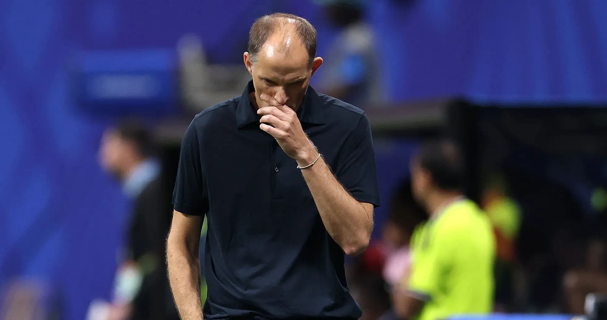Coach walking with head down on sidelines