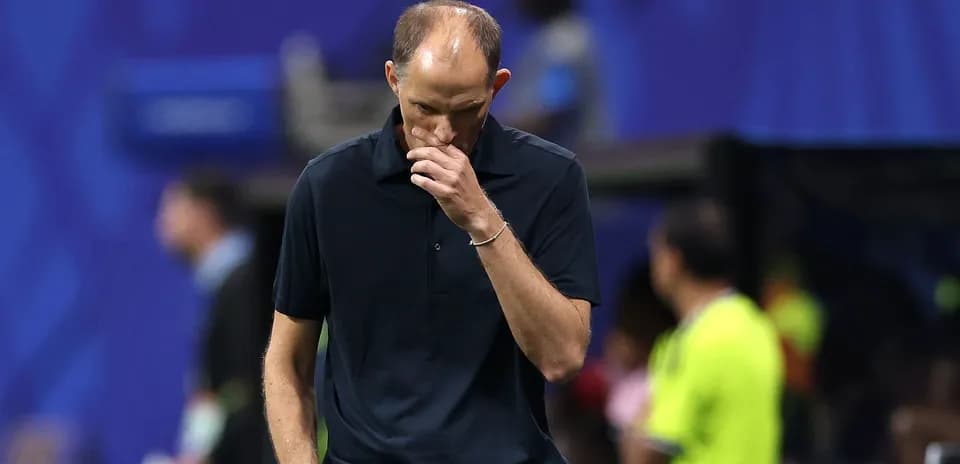 Coach walking with head down on sidelines