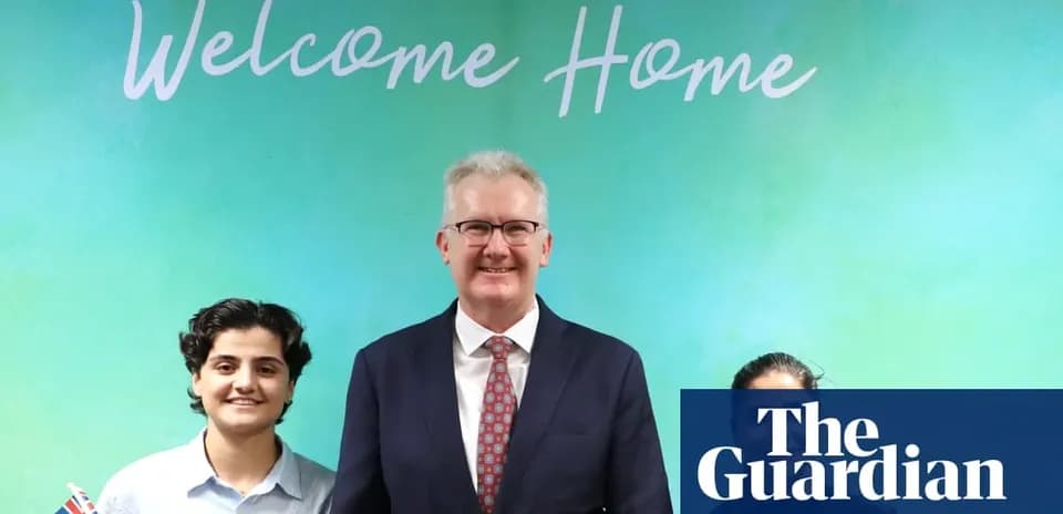 People posing in front of 'Welcome Home' banner