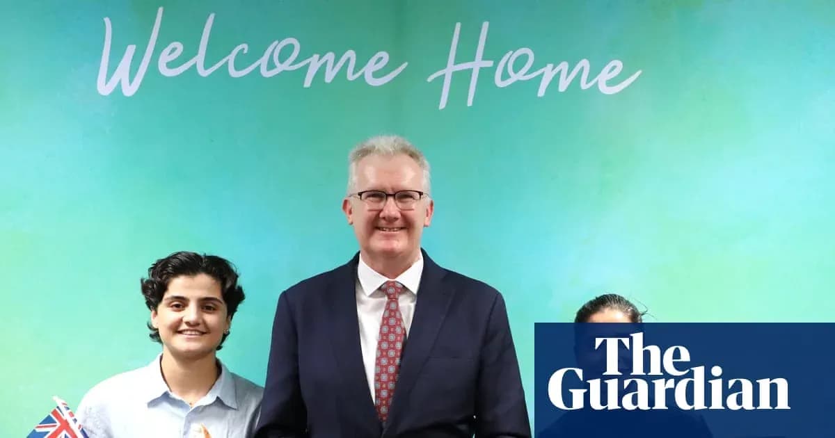 People posing in front of 'Welcome Home' banner