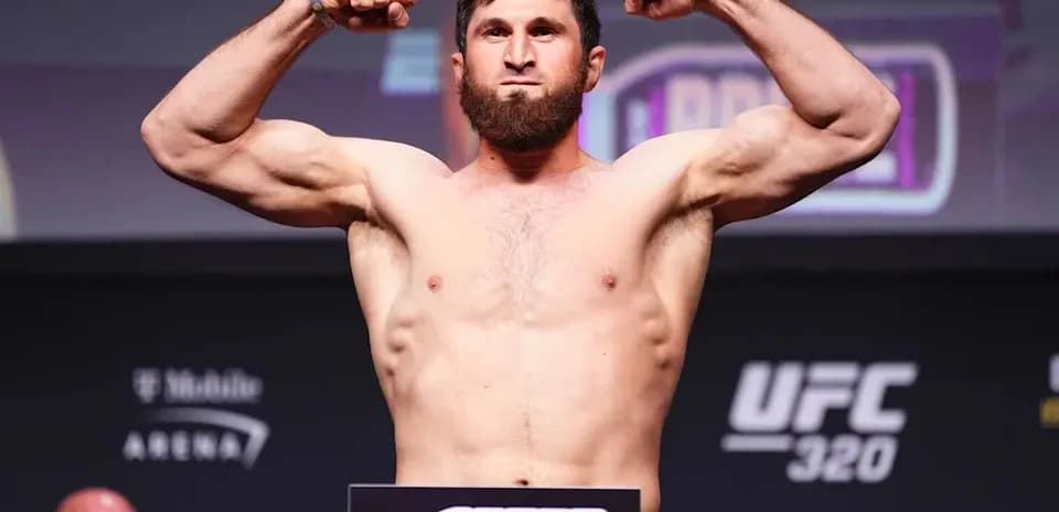Fighter weighing in with arms flexed at UFC event