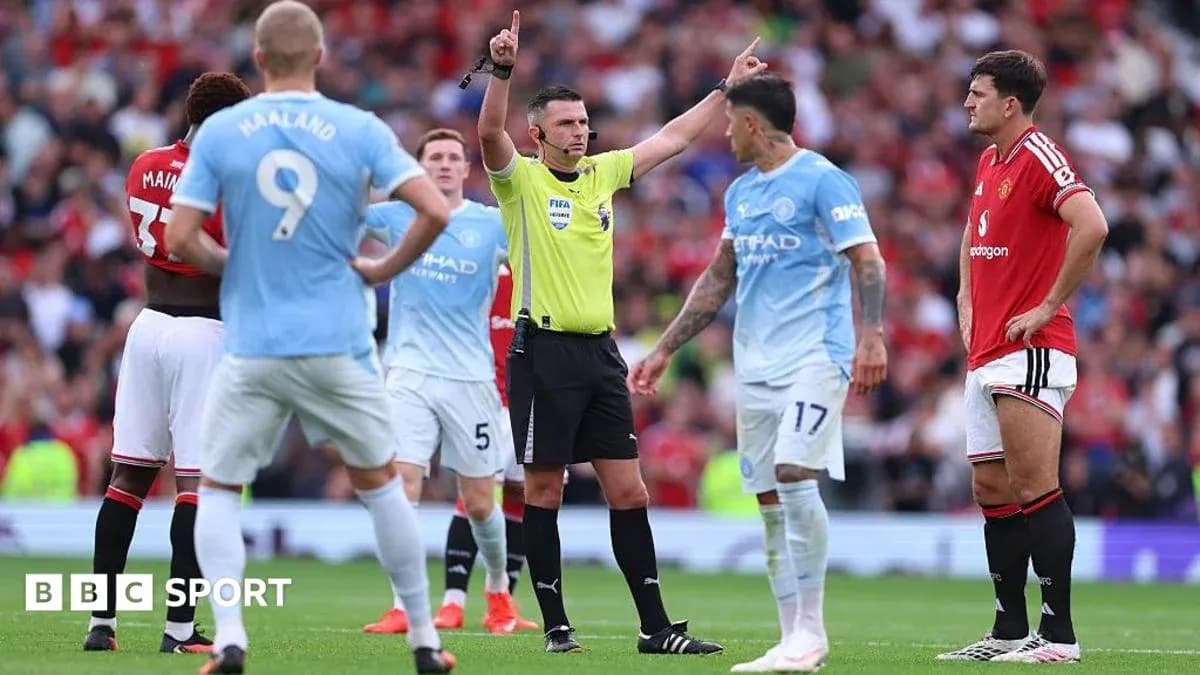 Referee signaling during Manchester United vs Manchester City match