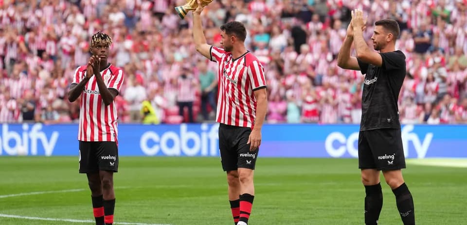 Athletic Bilbao players celebrating with trophy at stadium