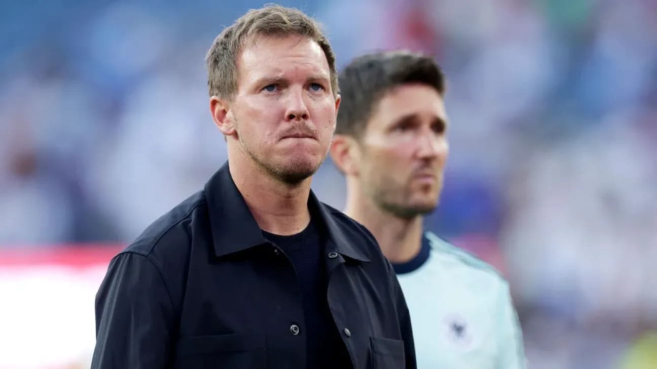 Two coaches standing together before a match