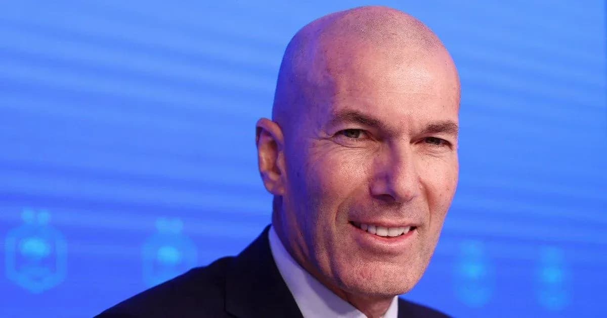 Bald man smiling at press conference backdrop