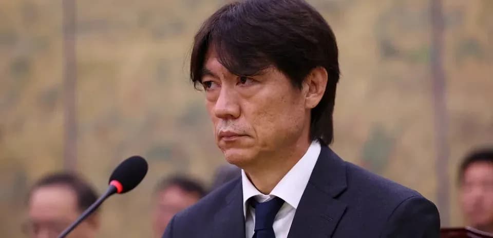 Man in suit speaking at press conference