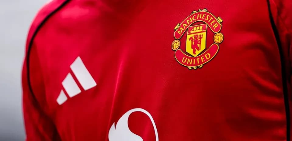 Manchester United logo on red football jersey