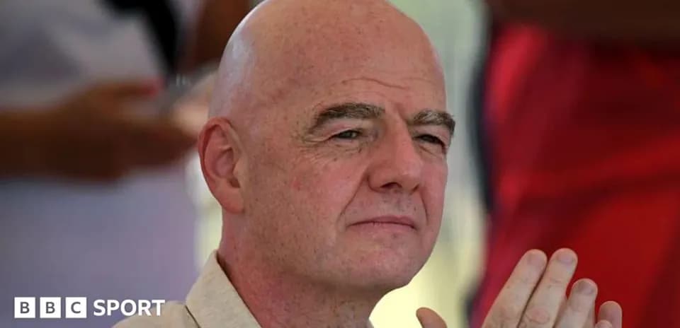 Man with bald head seated and listening attentively
