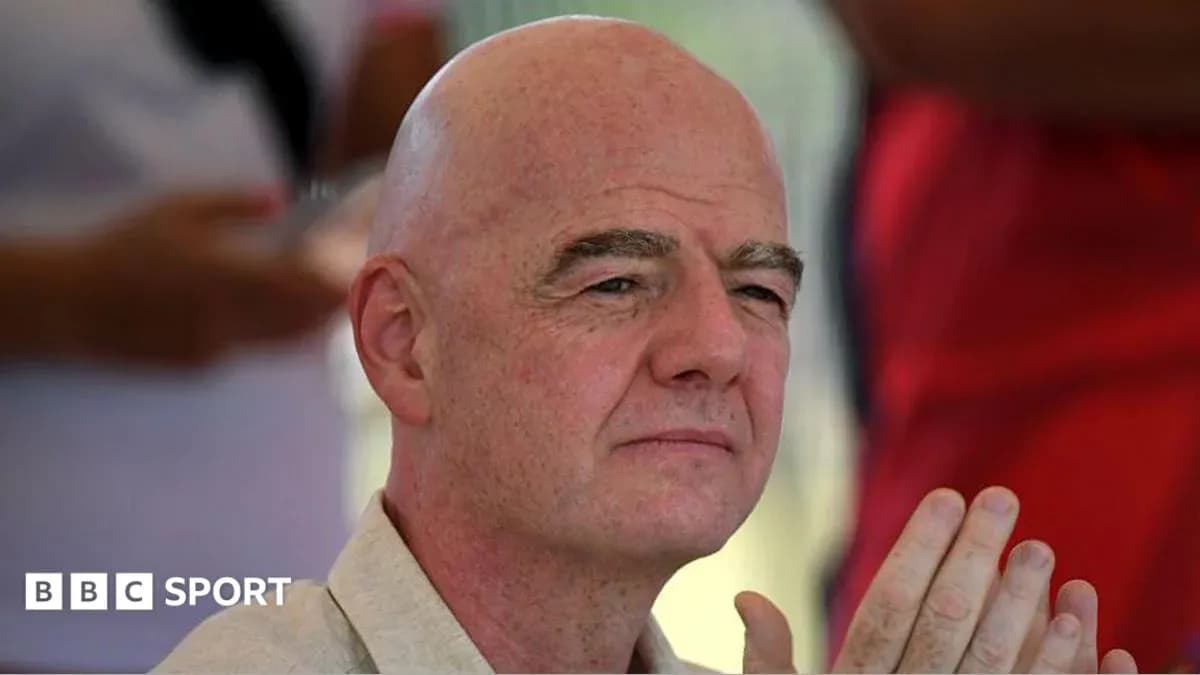 Man with bald head seated and listening attentively