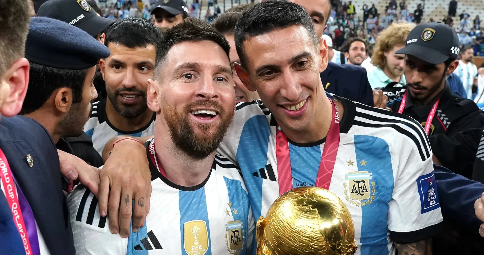 Lionel Messi and Ángel Di María celebrating with trophy