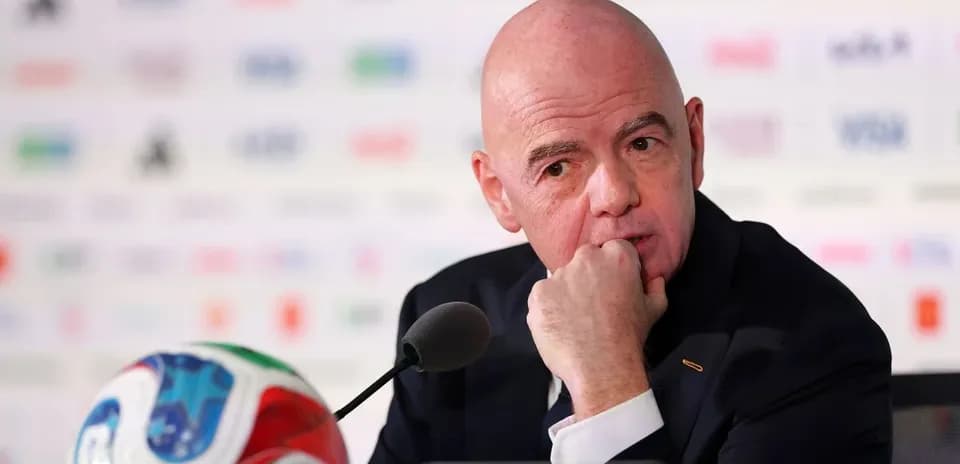 FIFA president at press conference with football