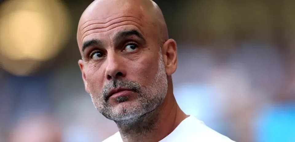 Bald coach looking towards the field during match